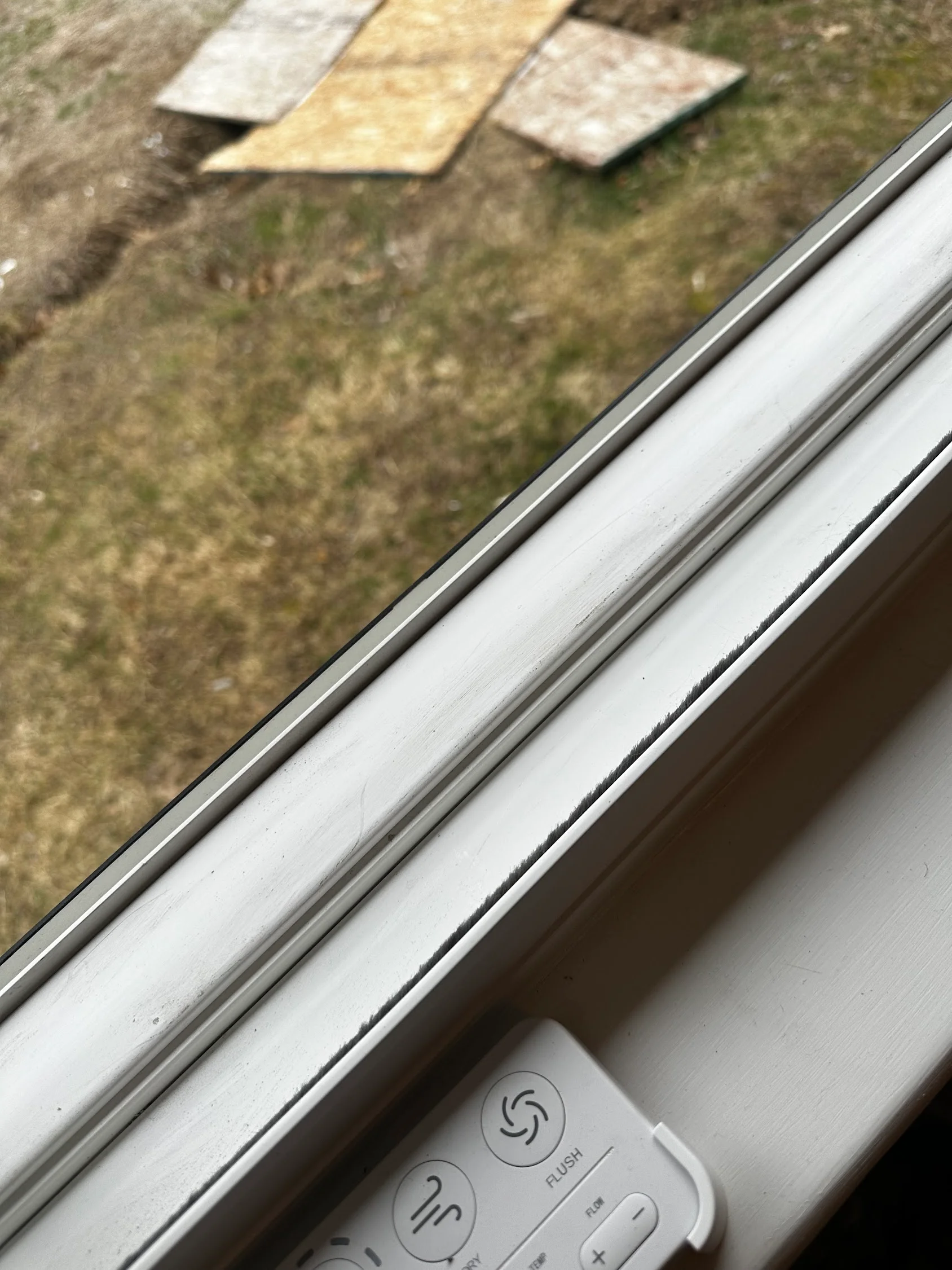 Clean white aluminum gutter and soffit trim with control panel visible below